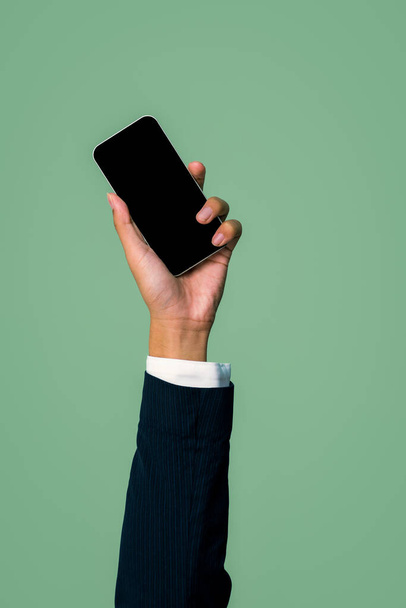 Hand hält Smartphone-Gerät auf isoliertem Hintergrund für Start-up-Mobile-Tech-Unternehmen. Umweltfreundliche grüne Unternehmen fördern die Idee der Elektroschrottpolitik. Urig - Foto, Bild