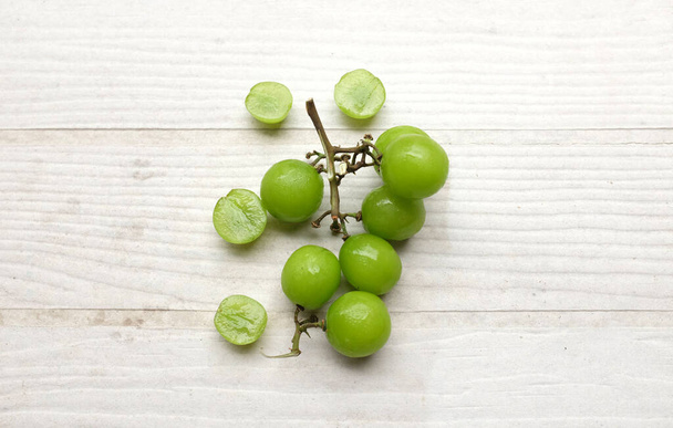 appetizing Freshness Japanese shine muscat grape and leaf isolated on white wooden background.green grapes. japanese grapes - Photo, Image