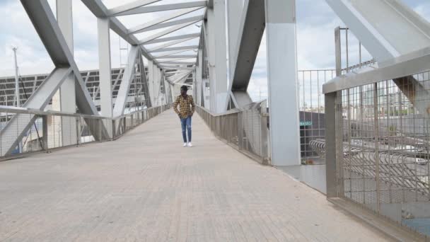 young man walking  on bridge - Footage, Video