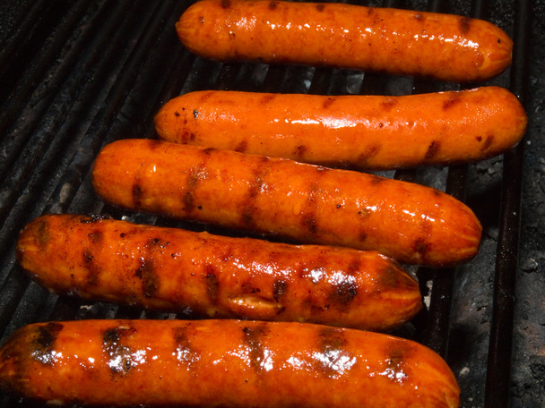 A row of five hotdogs on a bbq grill - Photo, Image