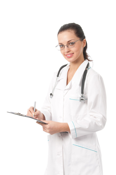 Happy doctor with stethoscope writing on clipboard, isolated - Foto, Bild