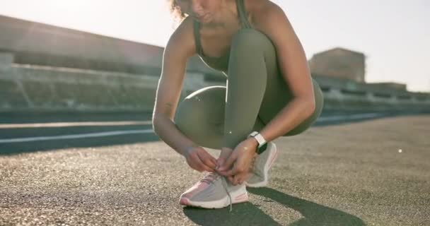 Tying laces, fitness and a woman in the city for running, sports or training in the street. Health, hiking and a runner or female athlete getting ready for exercise, marathon or cardio with shoes. - Footage, Video