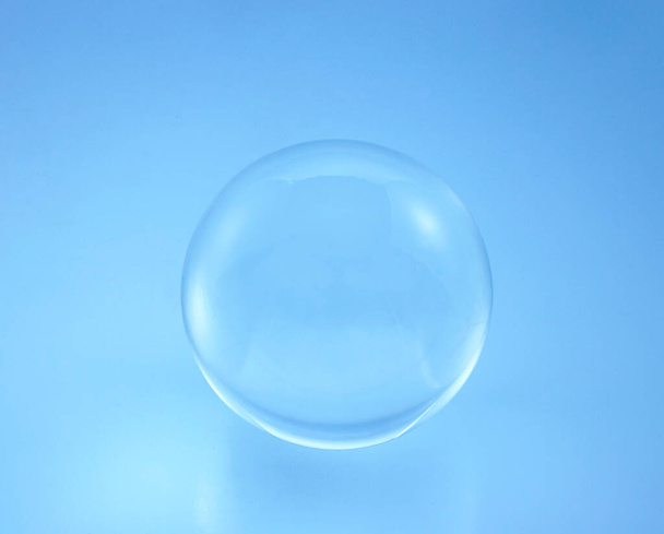 glass ball on blue background. - Photo, Image