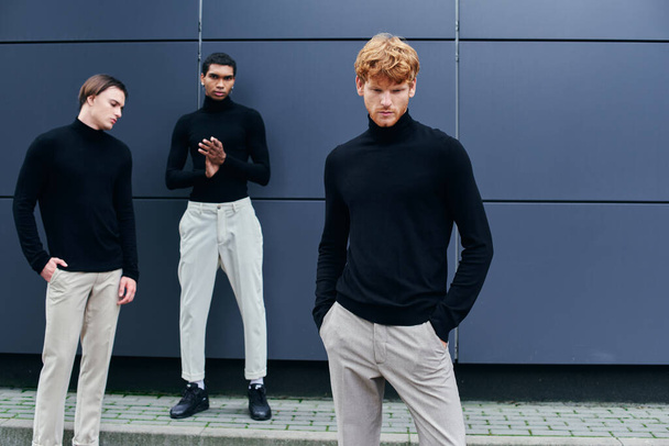 handsome stylish men in black turtlenecks with accessories posing by wall outside, fashion concept - Photo, Image