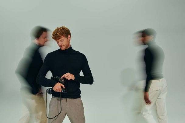 red haired man with retro phone with motion blur of other male models, long exposure, men power - Photo, Image