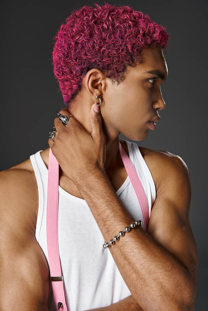 portrait of young african american man with silver accessories and pink hair, fashion and style - Photo, Image