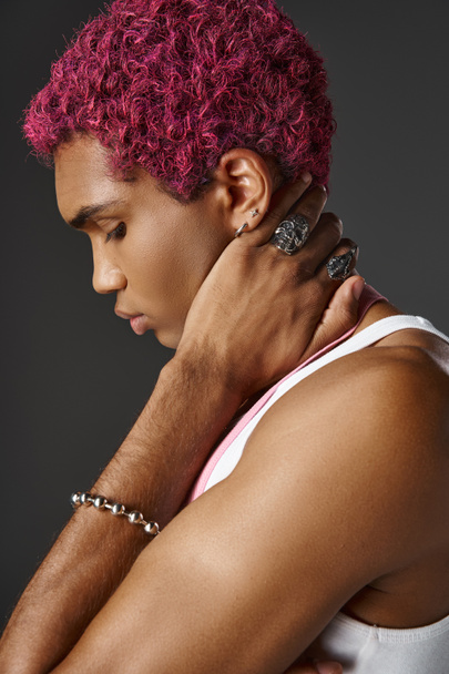 portrait of handsome pink haired man posing in profile wearing accessories, fashion and style - Photo, Image
