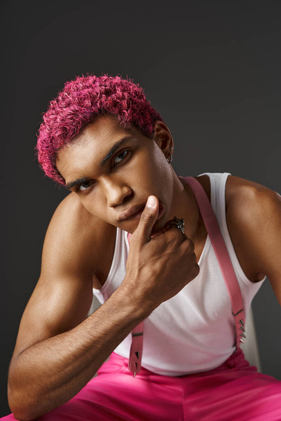 portrait of good looking pink haired man in stylish attire with hand on his lips, fashion concept - Photo, Image