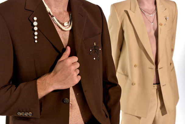 cropped view of young male models in elegant unbuttoned suits posing on white backdrop, men power - Photo, Image