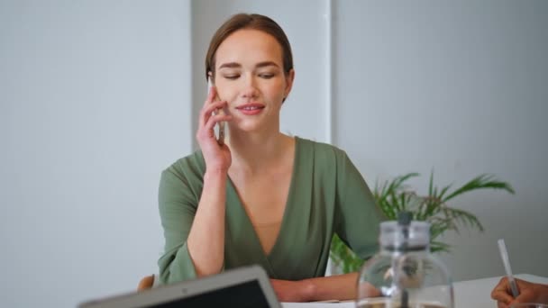 Confident manager making call on business meeting. Smiling girl talking support service in office. Attractive successful businesswoman ceo using smartphone on team meeting. Designer consulting client - Footage, Video