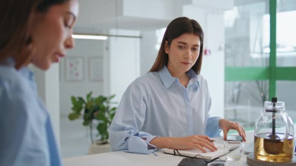 Young assistant working boss in office. Focused manager checking papers on team meeting. Successful employee corporate intern learning helping businesswoman. Professionals cooperation concept. - Footage, Video