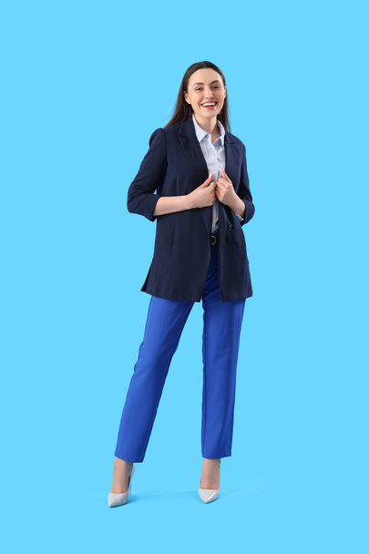 Giovane donna in abito elegante su sfondo blu - Foto, immagini