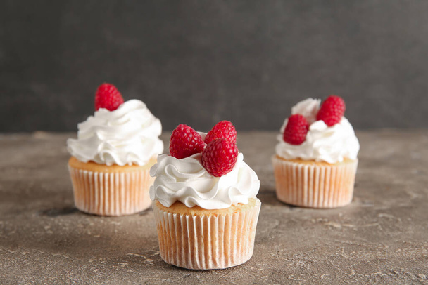 Tasty raspberry cupcakes on table - Photo, Image