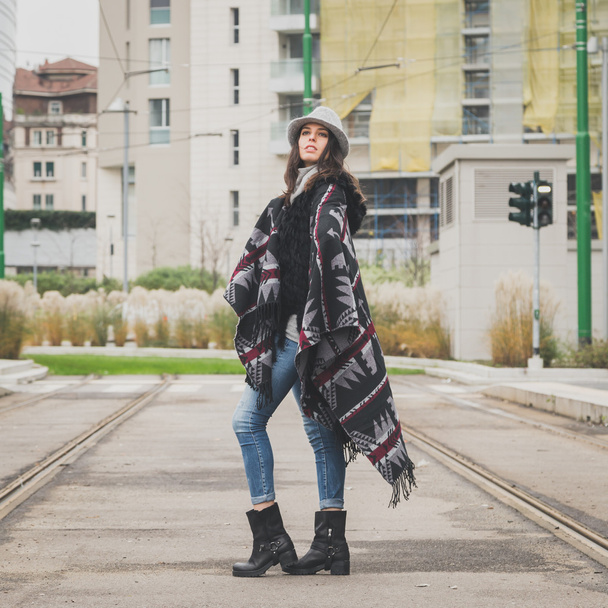 Beautiful young brunette posing in the city streets - Фото, зображення