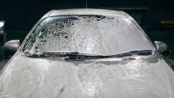 Car in foam. Car getting a wash with soap, car washing. Car close up. - Photo, Image