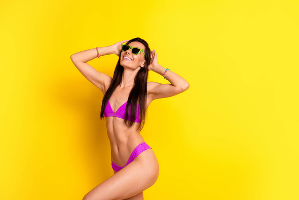 Portrait of skinny stunning girl have good mood dancing enjoy weekend empty space isolated on yellow color background. - 写真・画像