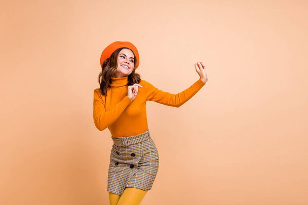 Photo of positive lady wear stylish orange clothes look empty space celebrate black friday big sale isolated on beige color background. - Photo, Image
