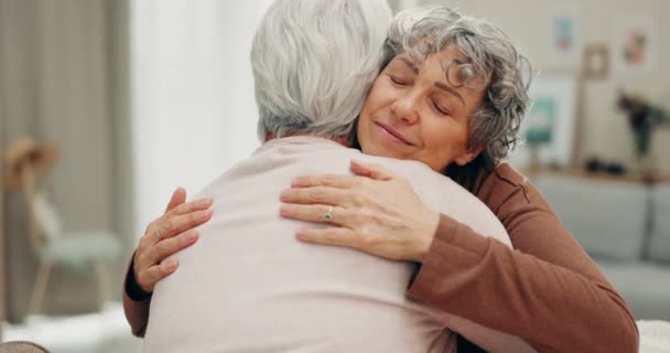 Support, face and senior friends hug in retirement friendship reunion, trust or enjoy time together in home lounge. Kindness, empathy or relax elderly people hugging, comfort and care from old women. - Video, Çekim
