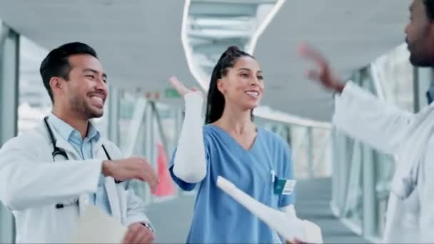 Doctors, nurses and high five, applause and success for teamwork, healthcare news or hospital motivation and support. Medical professional, diversity and group of people with hands together in clinic. - Footage, Video