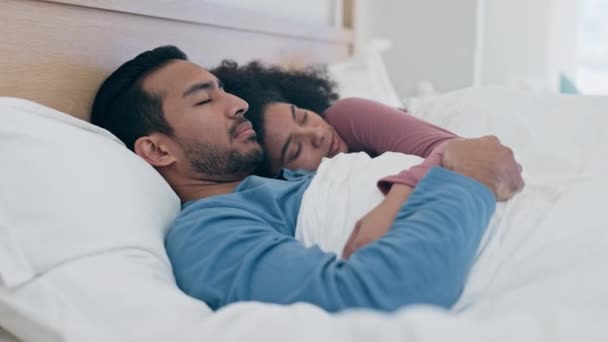 Couple, sleep and wake up in bedroom at morning with tired, relax or rest. Happy partnership, calm and home in hug or dream for marriage or together, peace on mattress or love in apartment or embrace. - Footage, Video