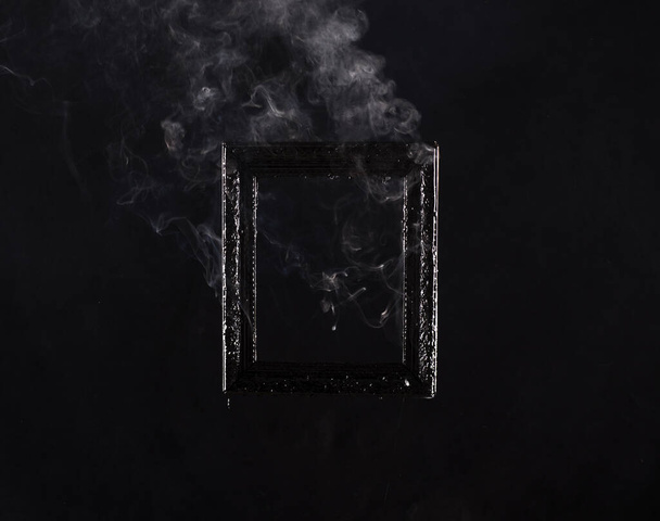 burning picture frame on a black background - Photo, Image