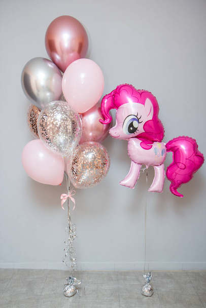 pink pony on a background of balloons, girl's birthday - Photo, Image