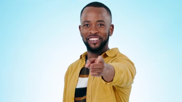 Pointing, you and happy black man on blue background for promotion, encouragement and choosing. Emoji, invite and portrait of person with hand gesture for thank you, agreement and decision in studio. - Footage, Video