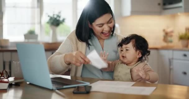 Mom, working from home and baby in kitchen, laptop and playing with paper, table and kid. Remote job, happy and freelancer for company, smiling and having fun with child in house, bonding, together. - Footage, Video