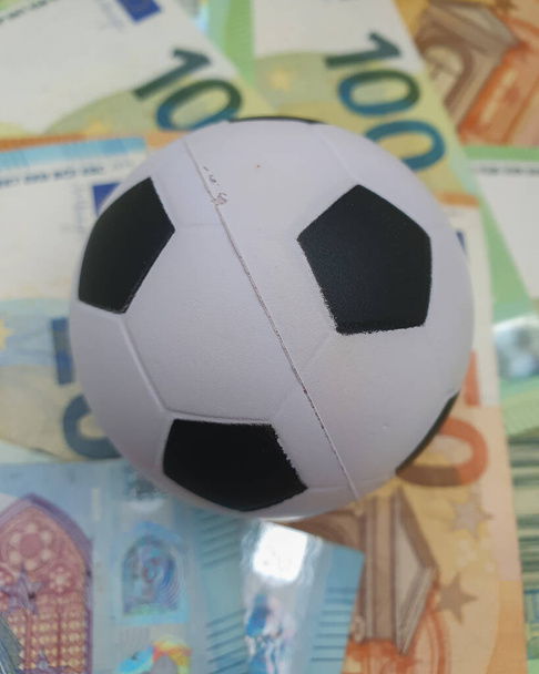 Euro coins and banknotes money currency of European Union and football ball useful as sport and money concept - Foto, imagen