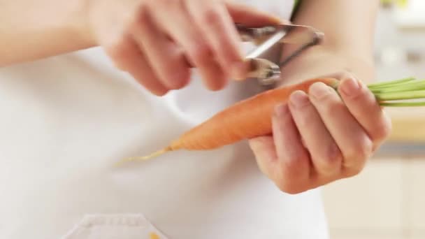 Carrot being peeled close up - Felvétel, videó