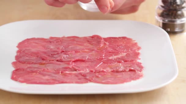 Beef carpaccio being seaded with salt - Footage, Video