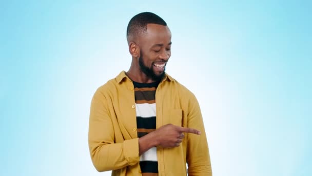 Black man, pointing and yes of decision for promotion, checklist and presentation for deal and choice. Blue background, studio and happy model with information and steps of advertising with a smile. - Footage, Video