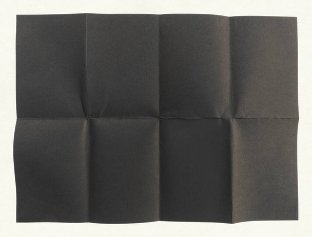 Крупним планом чорний папір, складений у вісім, текстурний фон - Фото, зображення
