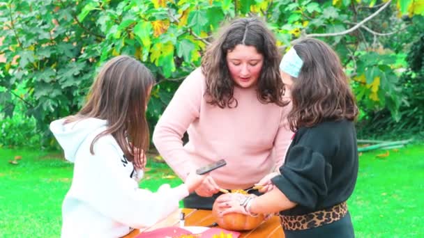 Young girls playing outdoor with a Halloween Pumpkin. - Footage, Video