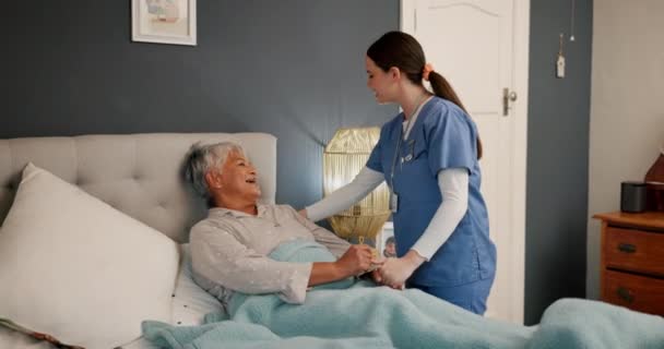 Mature, woman and patient with nurse in bedroom for assistance, comfort or recovery in health. Elderly, person and happy for care, consultation or help in retirement, rehabilitation or medical staff. - Footage, Video