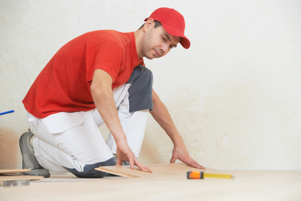 carpenter worker joining parket floor - Foto, Imagen
