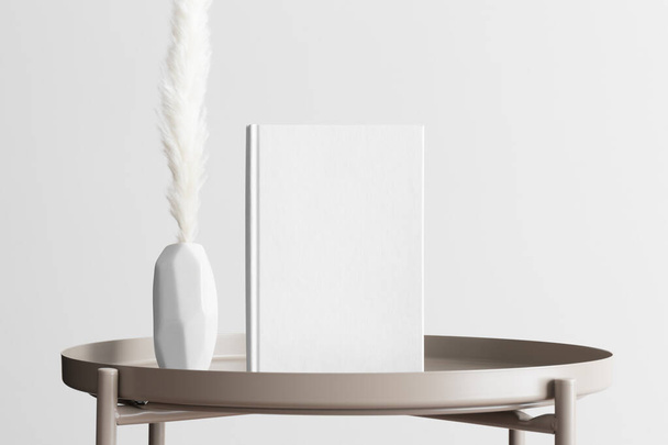 Mockup libro bianco con una decorazione pampas sul tavolo beige. - Foto, immagini
