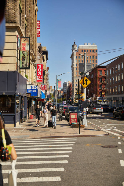 NEW YORK, USA - NOVEMBER 26, 2022: pedestrians walking along busy street in asiatown - Foto, imagen