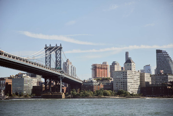 Manhattan bridge over east river and picturesque new york cityscape with modern skyscrapers - Photo, Image