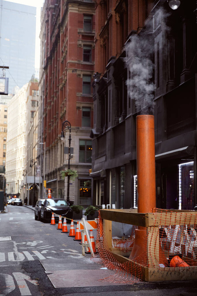 ventilation pipe steaming on narrow roadway in new york city, metropolis streetscape - Photo, Image