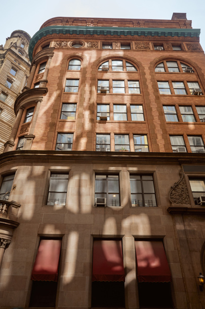 architecture of new york city, low angle view of vintage building with stone decor, urban scene - Photo, Image