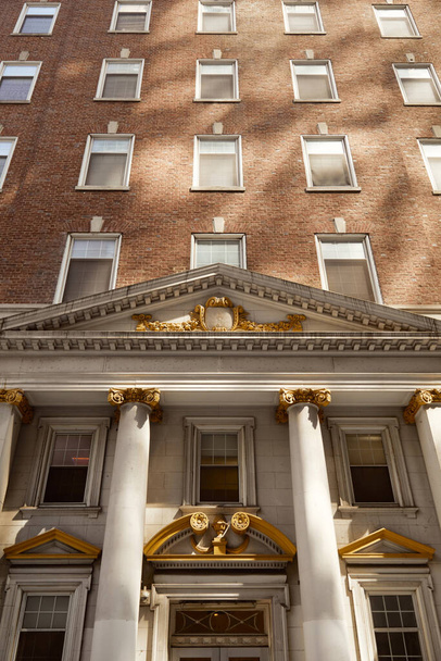 vintage architecture of new york city, low angle view of brick building with columns and portico - Photo, Image