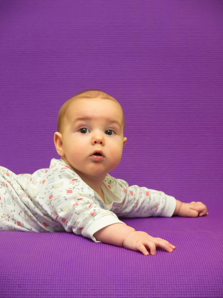 Infant on a purple background. - Photo, Image