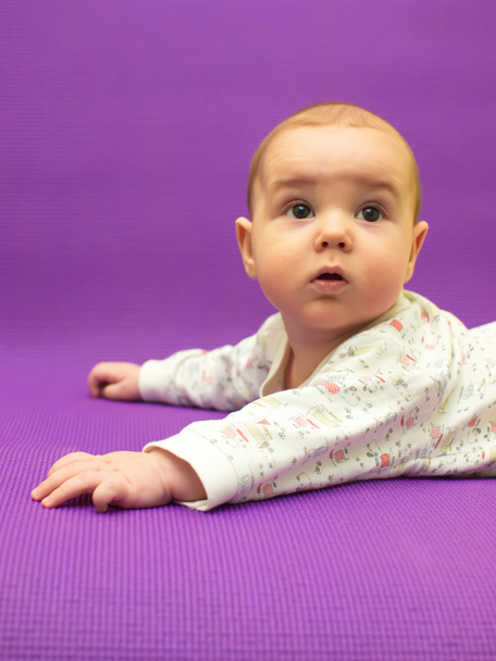 Infant on a purple background. - Photo, Image