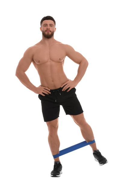 Young man exercising with elastic resistance band on white background - Fotó, kép