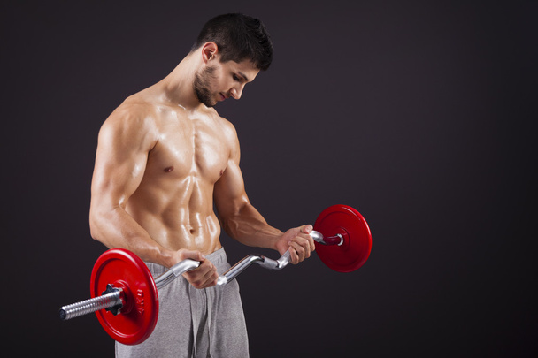 Fitness man lifting weights with curl bar - Zdjęcie, obraz