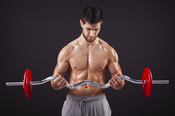 Fitness man lifting weights with curl bar - Fotoğraf, Görsel