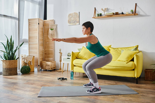 atraktivní sportovní žena ve sportovním oblečení squatting s rukama před ní, fitness a sport - Fotografie, Obrázek