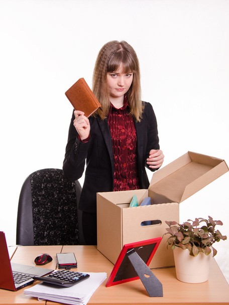 Dismissed girl office throws a notebook in box - Photo, Image