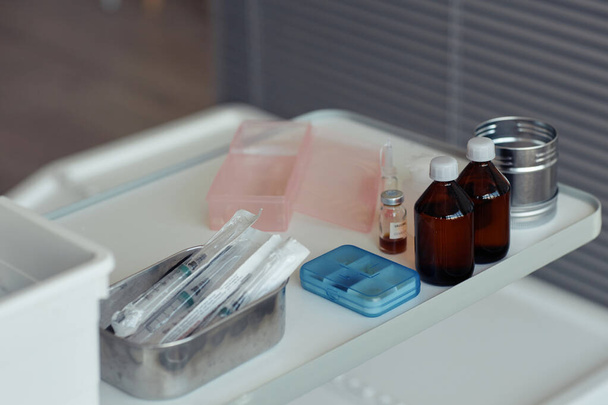 Close up of medical supplies on table in clinic with syringes and vaccination solutions - Photo, Image